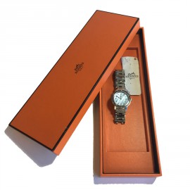 HERMES clipper watch with a blue mother of pearl background 